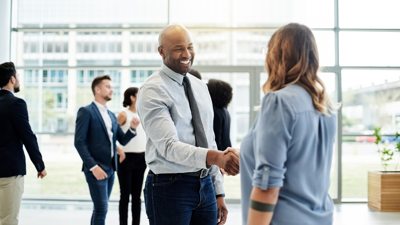 guy shaking a woman's hand